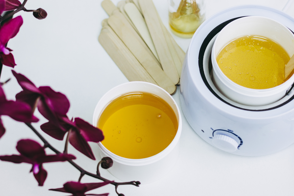 Orchid flower, aromatic sticks and paste for sugaring in beauty salon